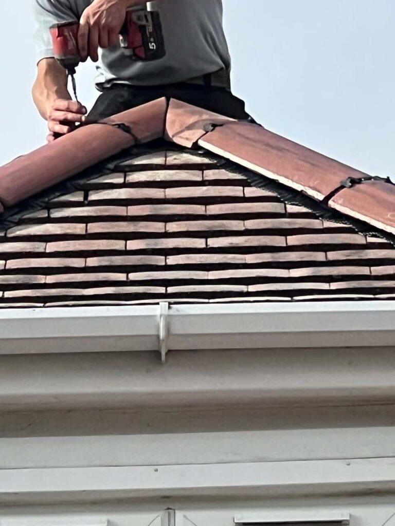 This is a photo of one of the operatives of Southampton Roofing Repairs installing new ridge tiles